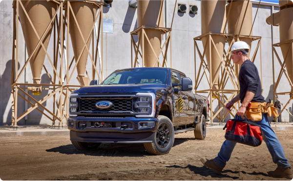 Construction worker heading toward his Ford Super Duty® on a worksite.
